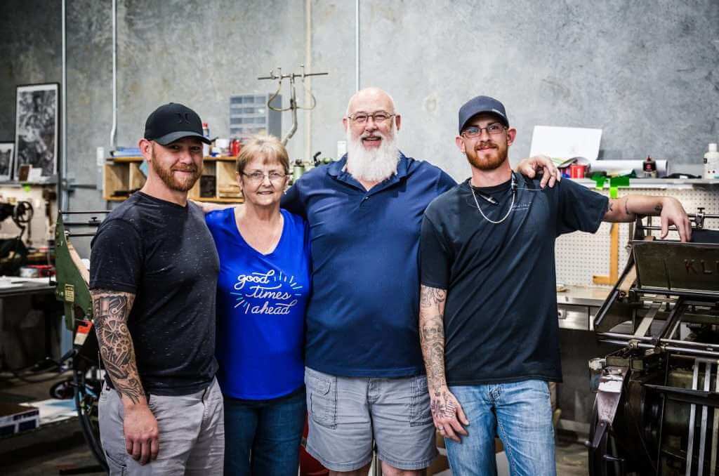 Letterpress printing team standing in a warehouse